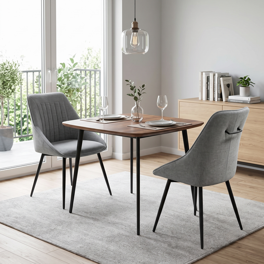 Pair of Crete dark grey fabric swivel dining chairs at a small wooden dining table in a bright room with a grey rug