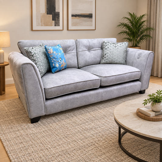 Mariah silver velvet 3 seater sofa in a living room with a jute rug, abstract art and a round stone coffee table