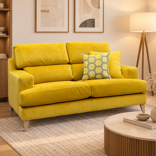Romilly golden spice yellow velvet 2.5 seater sofa in a living room with a round coffee table and floor lamp