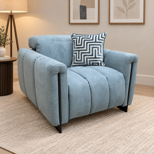 Girgio light blue velvet recliner chair in a living room with a cream rug and side table lamp