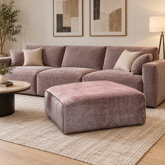 Garland California pink fabric footstool in front of a matching sofa in a neutral living room