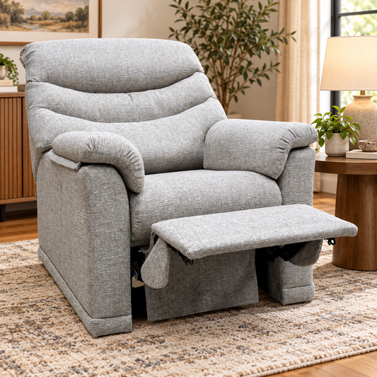 G Plan Malvern oatmeal fabric recliner chair reclined in a living room beside a wooden side table and lamp