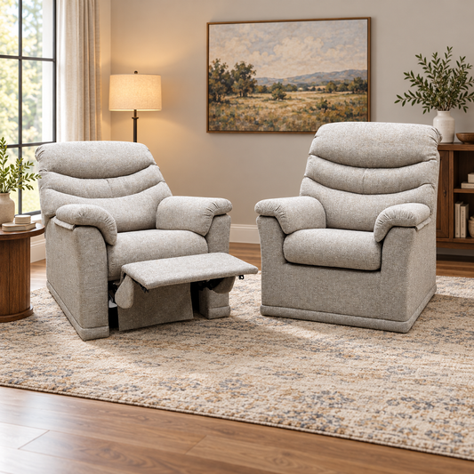 G Plan Malvern oatmeal fabric recliner and standard chair pair in a living room with a landscape painting