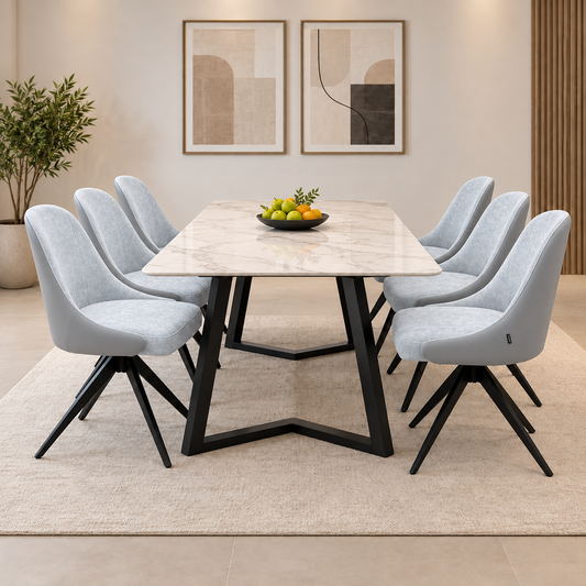 The six Jose stone grey faux leather swivel dining chairs around a white marble-effect table on a black base