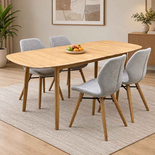 Stockholm light oak extending dining table and four light grey chairs in a room scene with a fruit bowl and rug