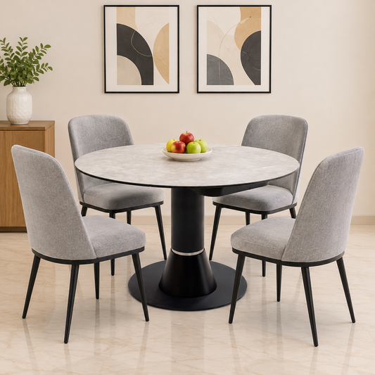Enterprise grey ceramic top round dining table in a dining room with four grey fabric chairs and a fruit bowl