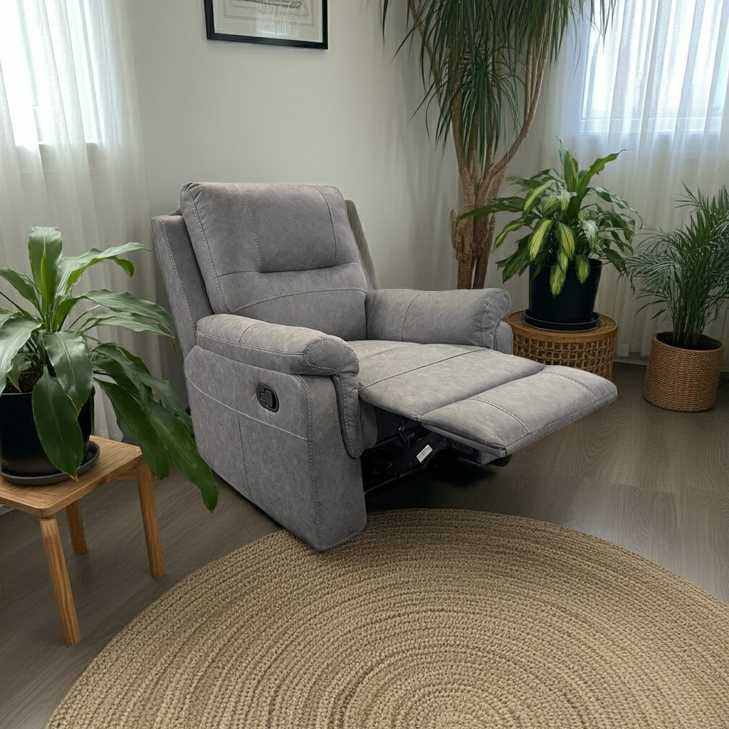 Gray recliner chair in a living room with plants and a round rug.