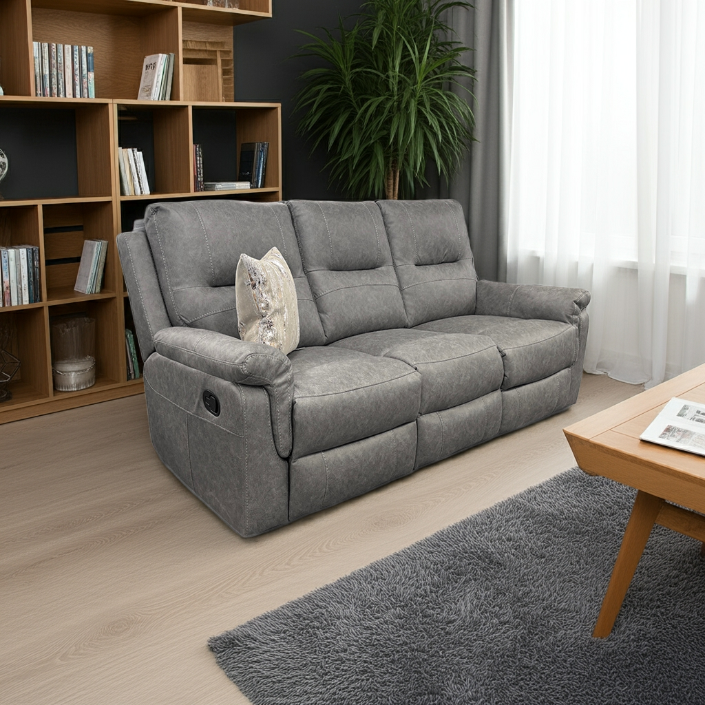 Gray sofa in a living room with wooden bookshelf and coffee table