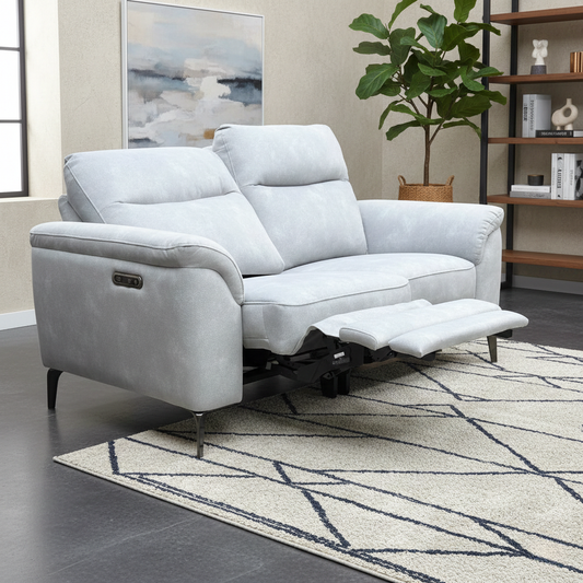 Morgan smoke grey velvet 2 seater power recliner sofa reclined in a living room with a geometric rug and shelving