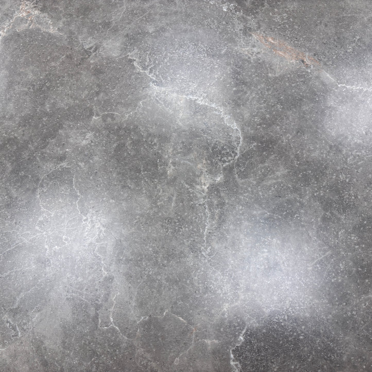 Close-up detail of the grey sintered stone ceramic tabletop, showcasing its smooth, durable, and stain-resistant surface.