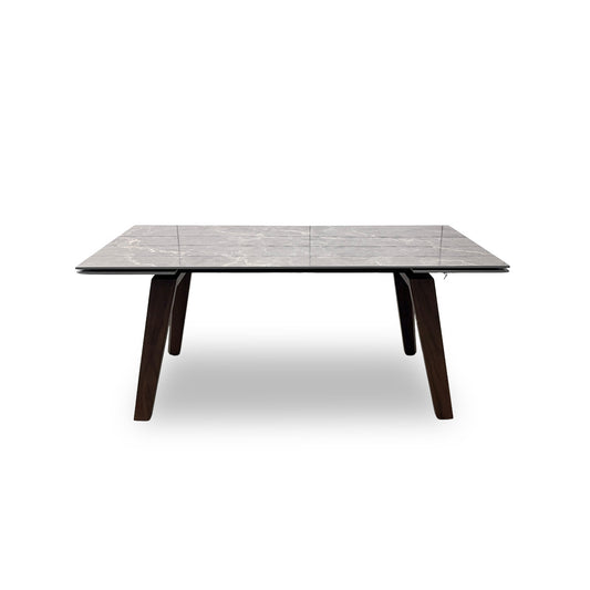 Demonstration of the extending dining table mechanism, showing a person pulling the table apart to reveal the hidden leaf.