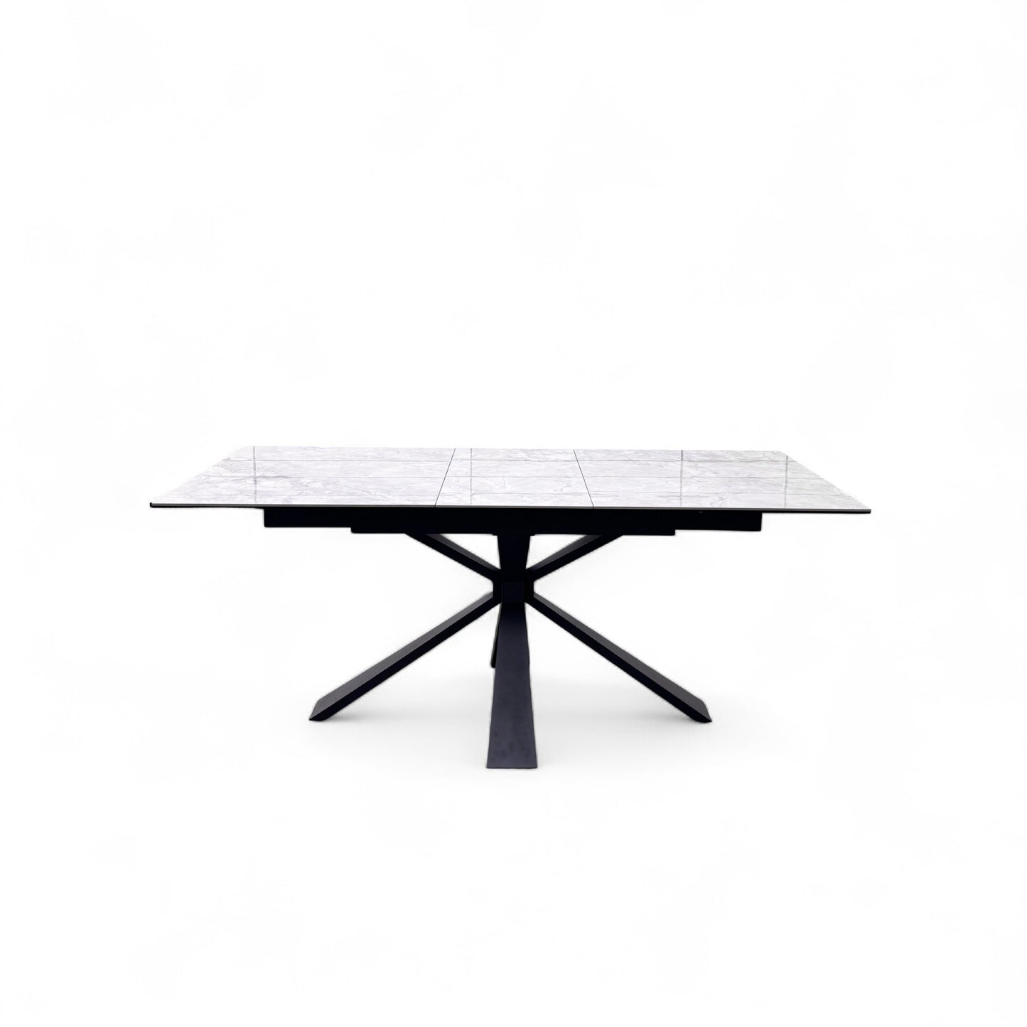 Front view of the Crete dining table extended to its full 180cm length, highlighting the smooth transition of the white ceramic top.