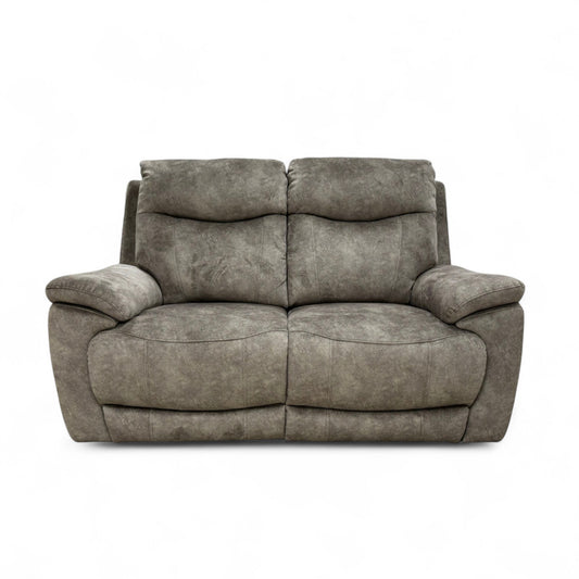 The Charcoal Grey Velvet Sloane Sofa with the power recliner footrest fully extended, showing the comfortable lounging position.