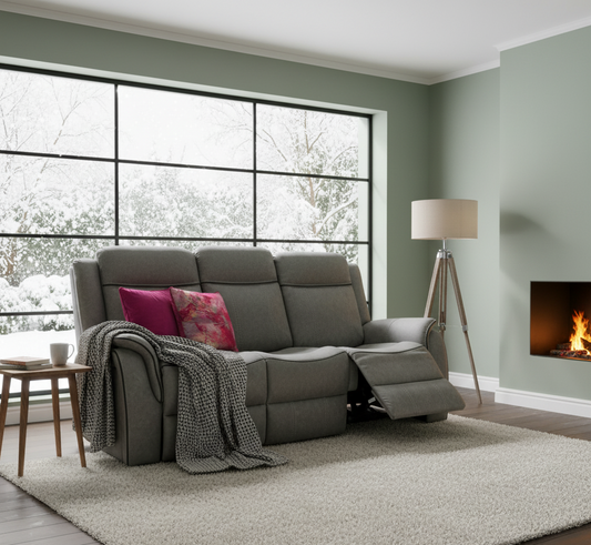 Gray sofa with colorful cushions in a modern living room with large windows and a fireplace.