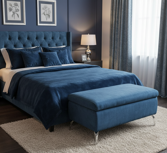 Blue upholstered bed with matching ottoman in a bedroom setting.