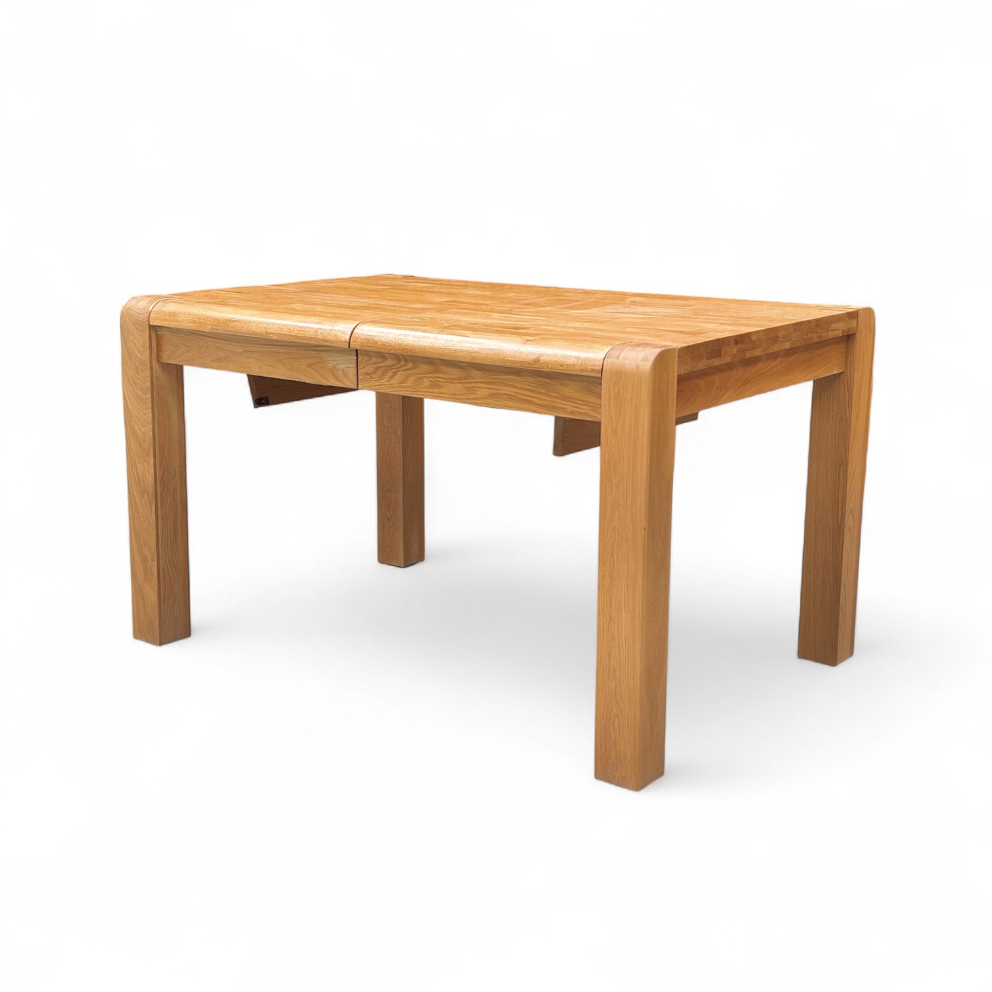 The 'Bakerloo' Solid Oak Dining Table fully extended to $180\text{ cm}$, showing the added leaf and increased seating capacity.
