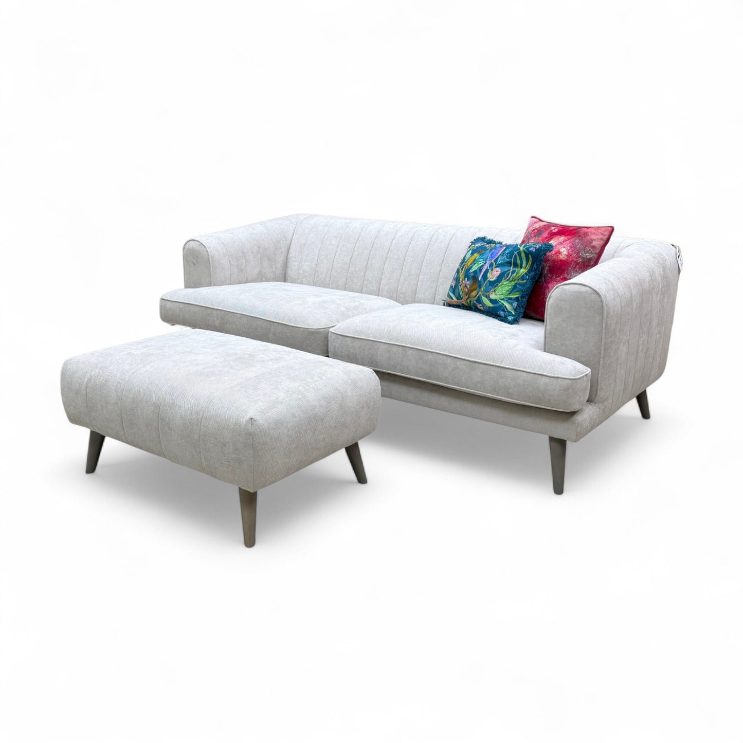 An angled view of the sofa and footstool, showing the clean lines and overall profile of the set.