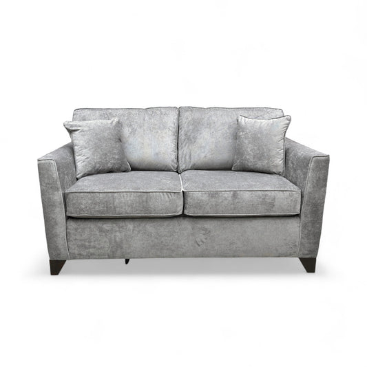 Frontal view of the ‘Smith’ Grey Fabric Sofa, emphasizing the size, armrests, and seat cushions.