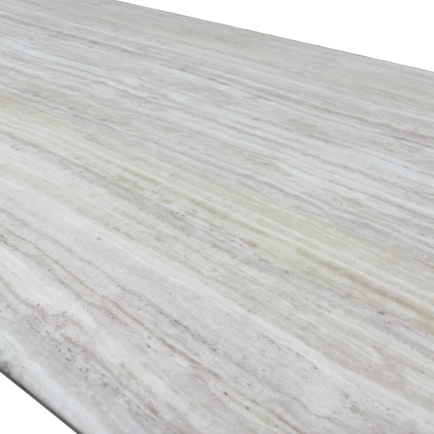 Close-up detail of the smooth travertine marble tabletop surface, showing its natural color variation and unique veining.