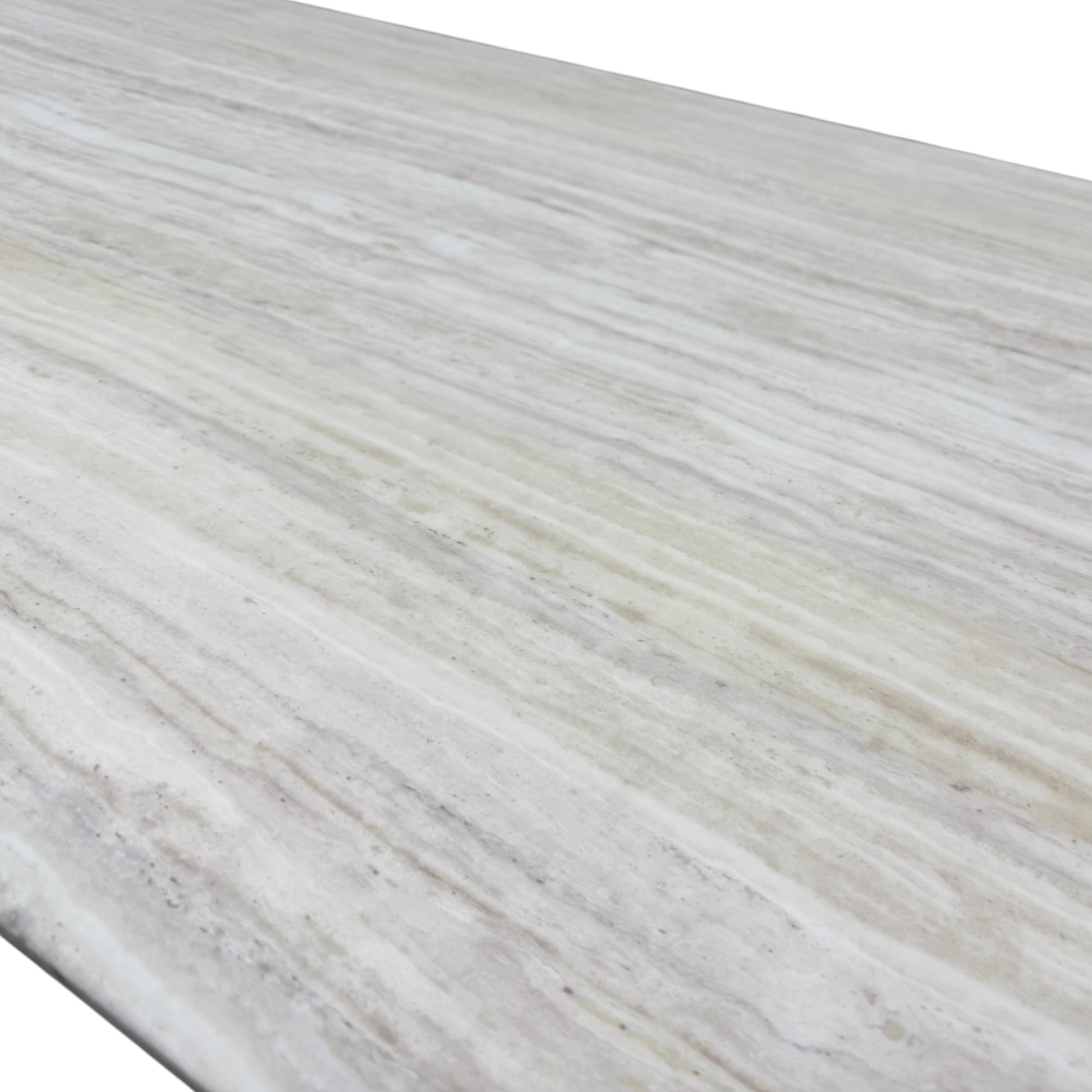 Close-up detail of the smooth travertine marble tabletop surface, showing its natural color variation and unique veining.