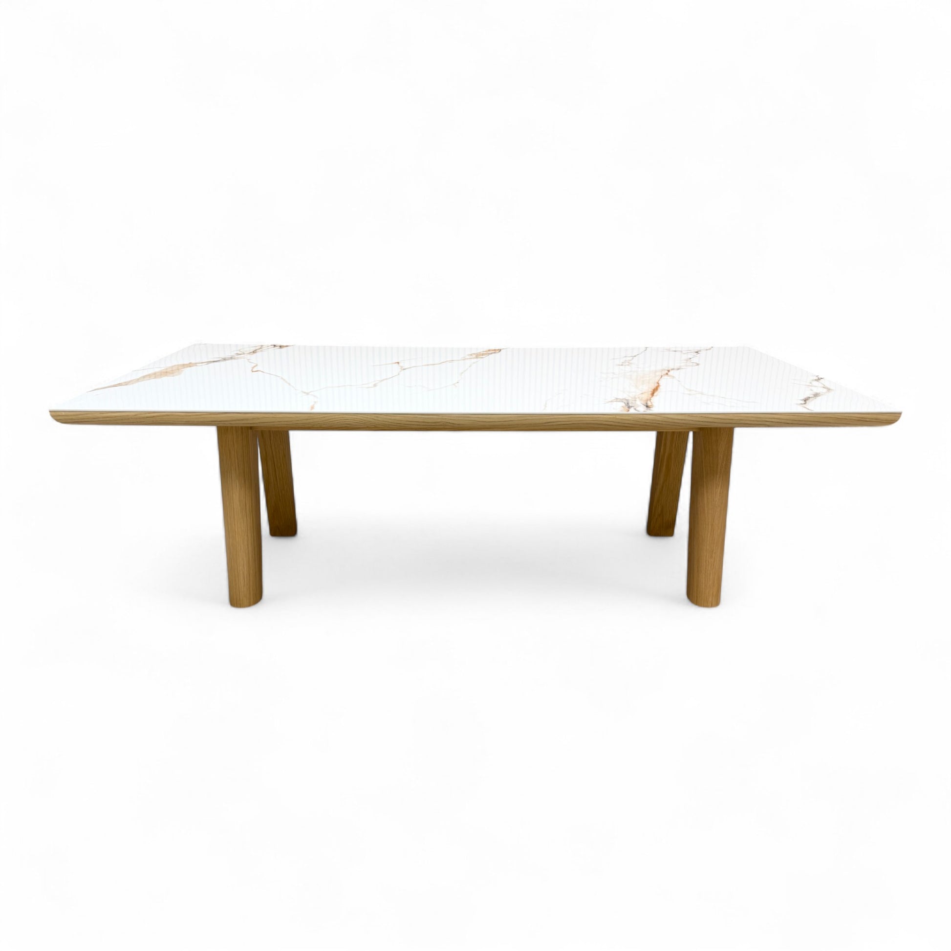 front side view of the 'Montreale' dining table, highlighting the glossy white ceramic surface and the thickness of the tabletop