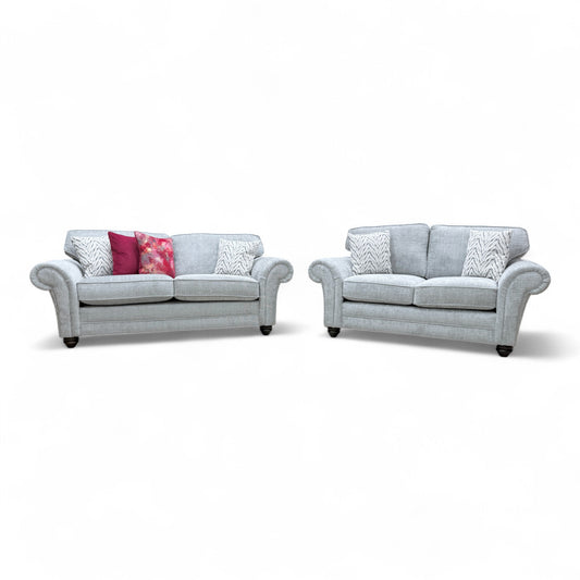 Front view of the 'Clara' 3-seater and 2-seater sofa set, showcasing the classic scroll arm design and silver woven fabric.