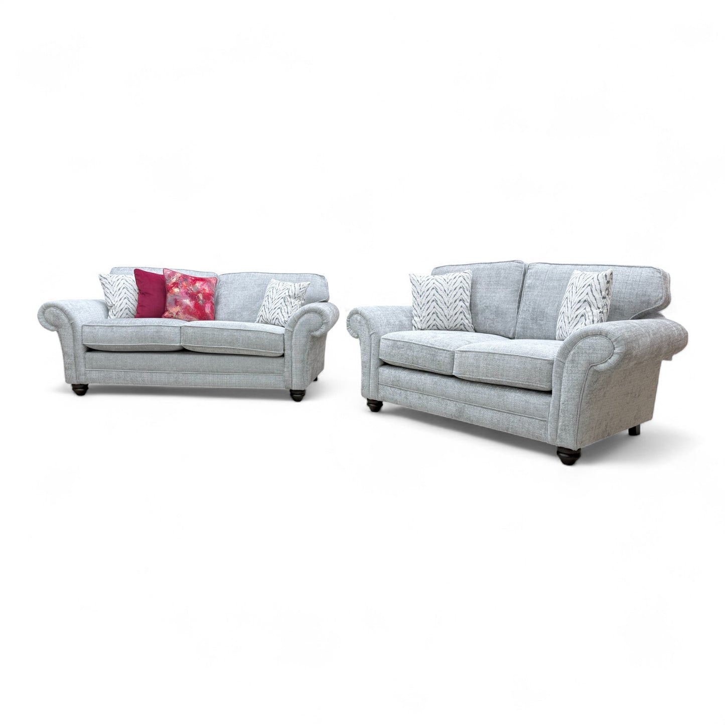 Angled view of the larger 'Clara' 3-seater sofa, highlighting the design details, scroll arms, and included scatter cushions.