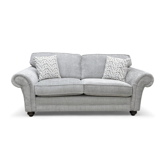 Full front view of the ‘Clara’ 3 Seater Sofa in silver woven fabric, showcasing the cushion back and scroll arms.