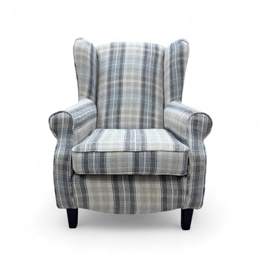 front view of the 'Shirley' armchair, highlighting the high back, scroll arm design, and the subtle checkered pattern of the fabric.