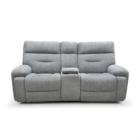 A full front-angled view of the Cinemax 2 Seater Sofa in charcoal grey fabric. The central console is closed, and the headrests are in the upright, non-reclined position.