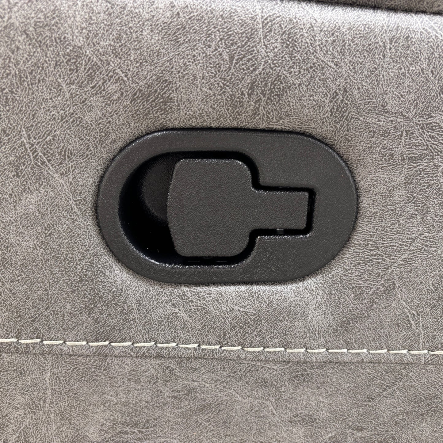 Close-up of a gray suitcase with a black handle on a matching gray background