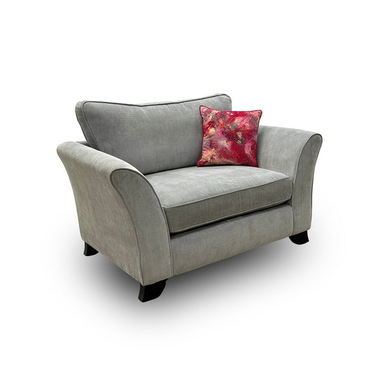 Full view of the 'Sasha' snugger armchair in soft light grey velour fabric, featuring deep-buttoned detailing and elegant dark wood legs.