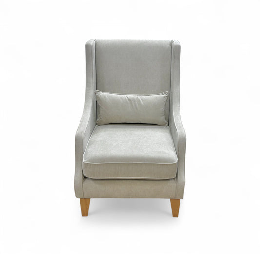 Gray armchair with a pillow on a white background