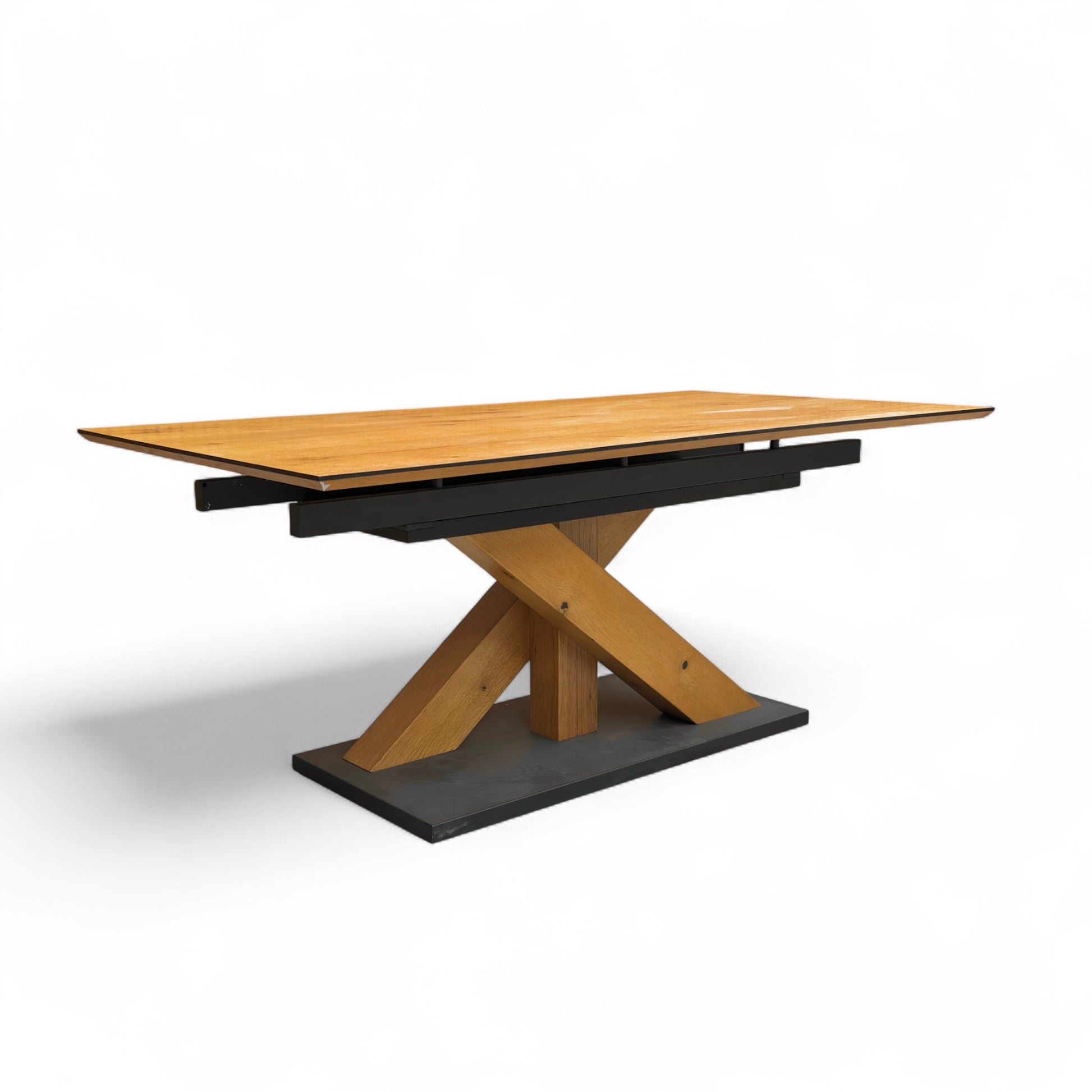 Wooden dining table with black base on a white background