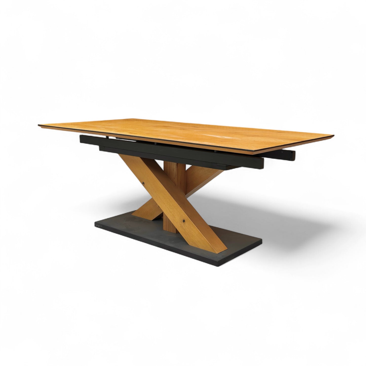 Wooden table with black metal base on a white background