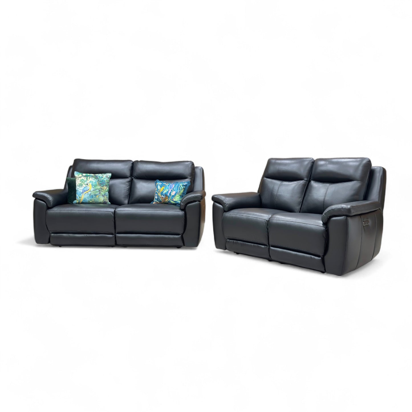 Black leather sofa set with floral cushions on a white background