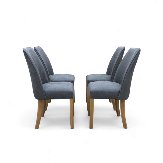 Four gray upholstered chairs with wooden legs on a white background