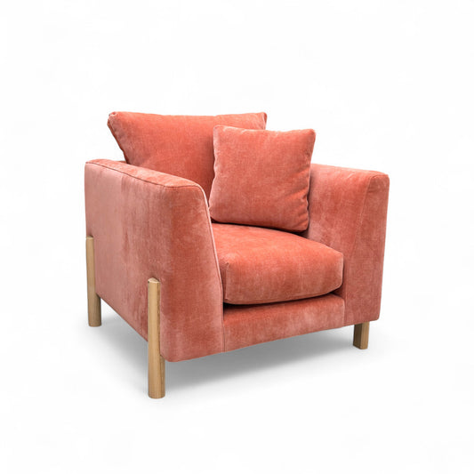 Orange armchair with cushions on a white background