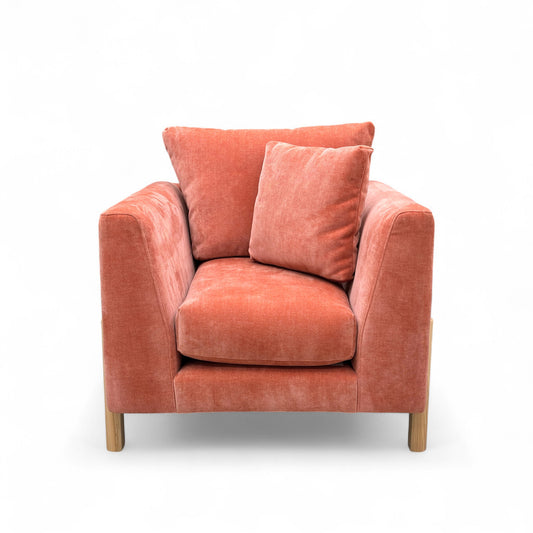 Orange armchair with cushions on a white background