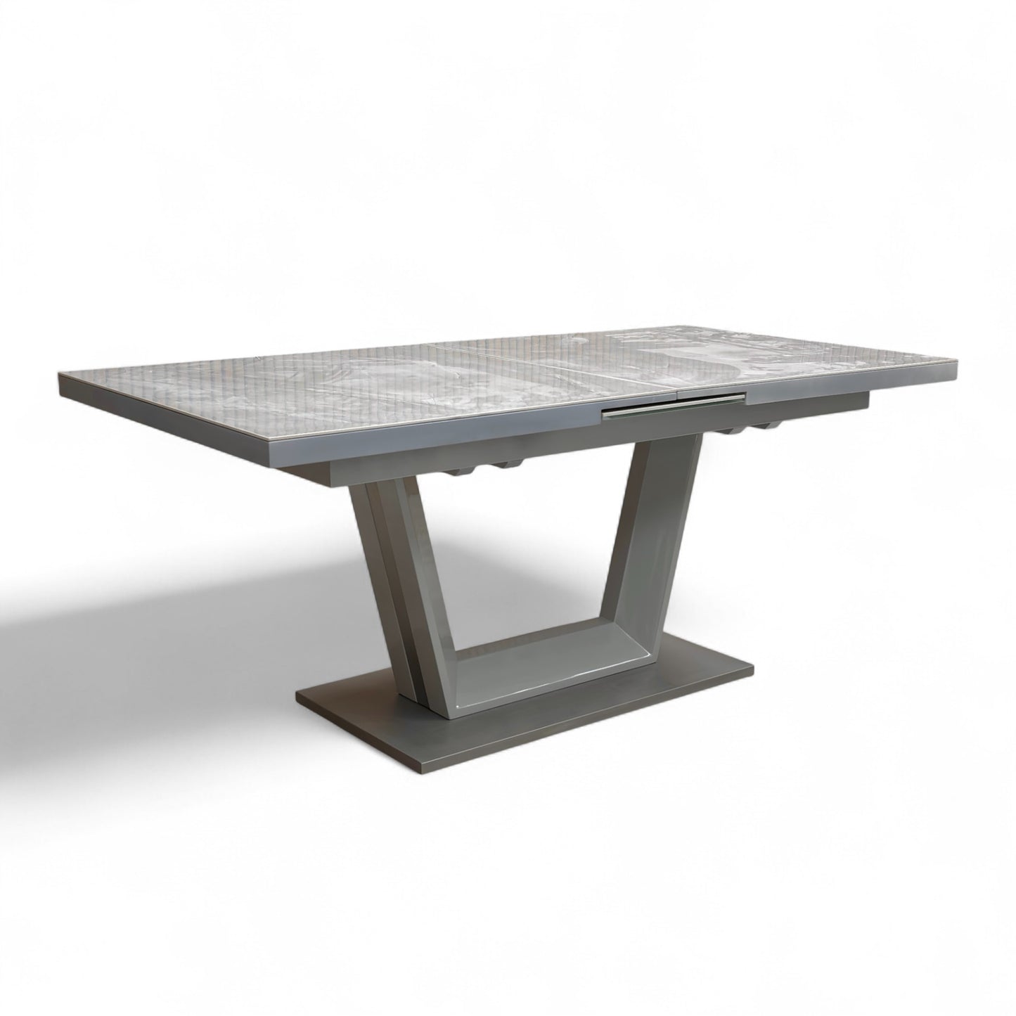 Angled view of the Grigio Large Extending Dining Table with its high-gloss, gray marble-effect ceramic top and modern U-shaped pedestal base.