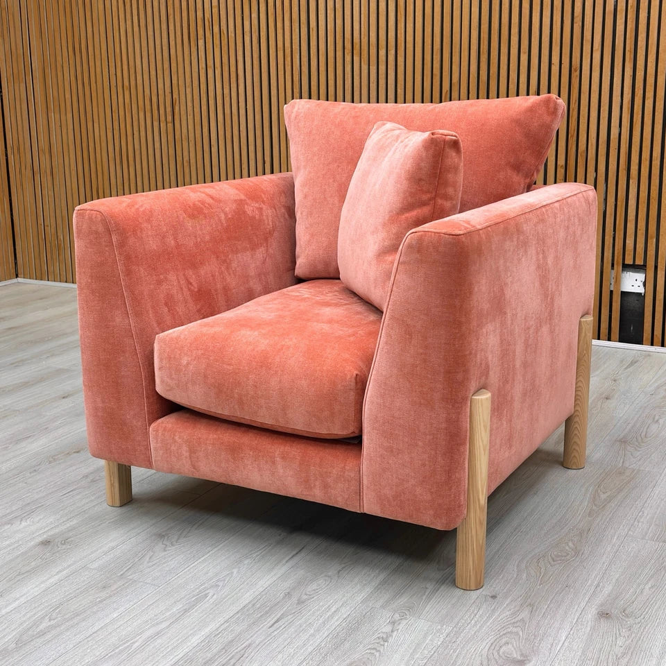 Orange armchair with cushions on a Wooden background