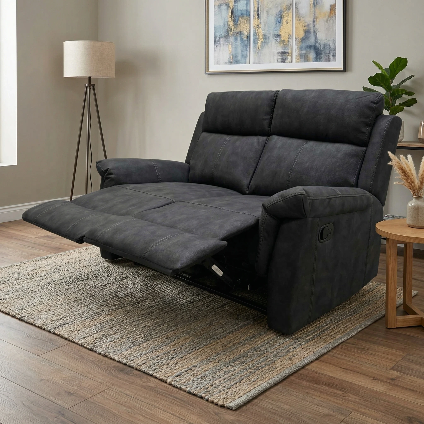 Living room shot of the Oscar charcoal leather 2-seater sofa in a contemporary living room setting.