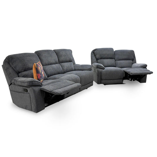 Full view of Costa sofa set including a 3-seater manual recliner with console and a matching 2-seater sofa in charcoal grey weave fabric.