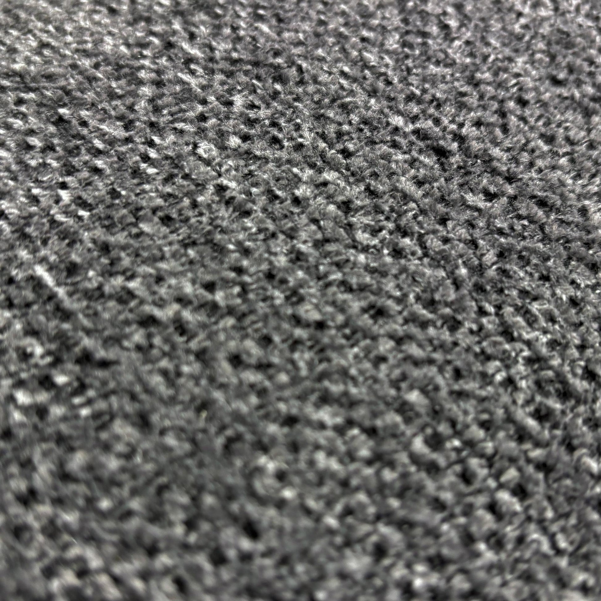 Close up view of the weave fabric texture and tailored stitching on the Costa sofa armrest.