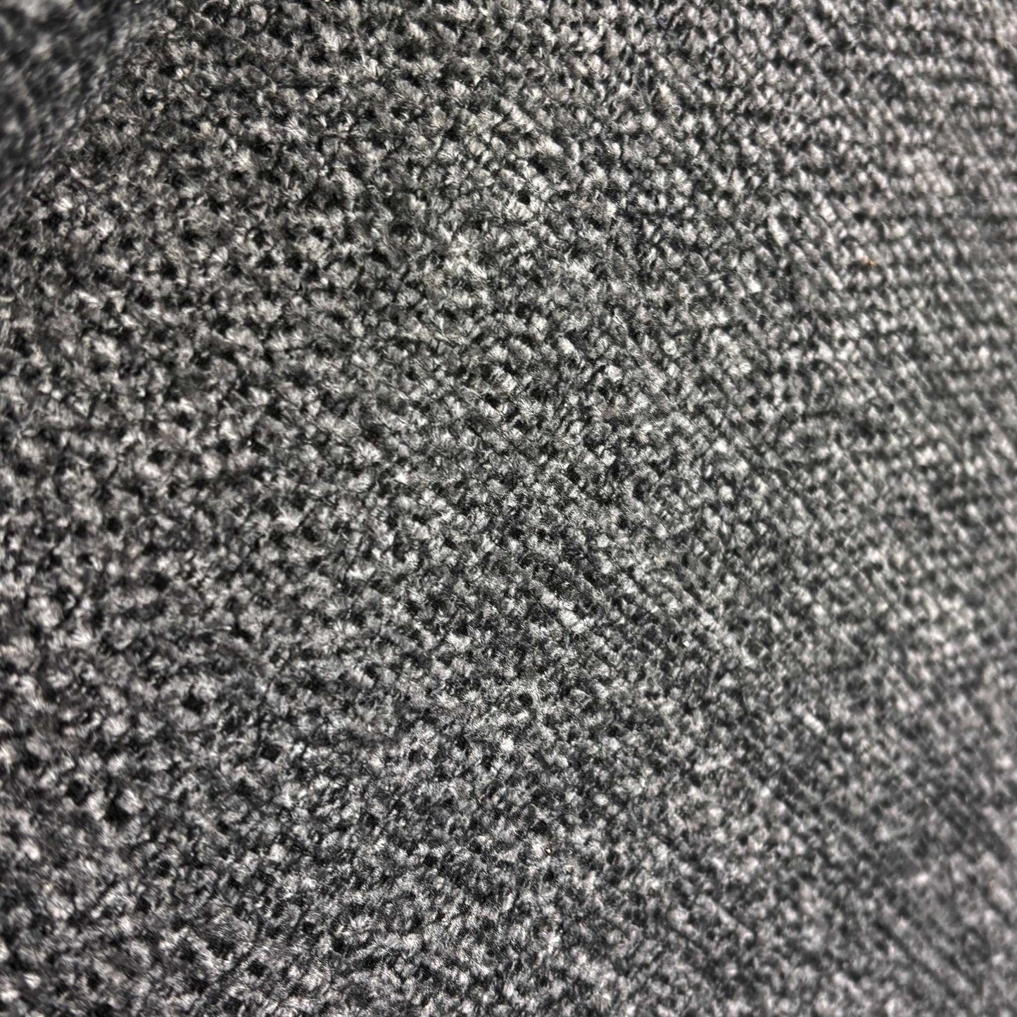 Close up view of the durable charcoal grey weave fabric and quality stitching on the Costa sofa.