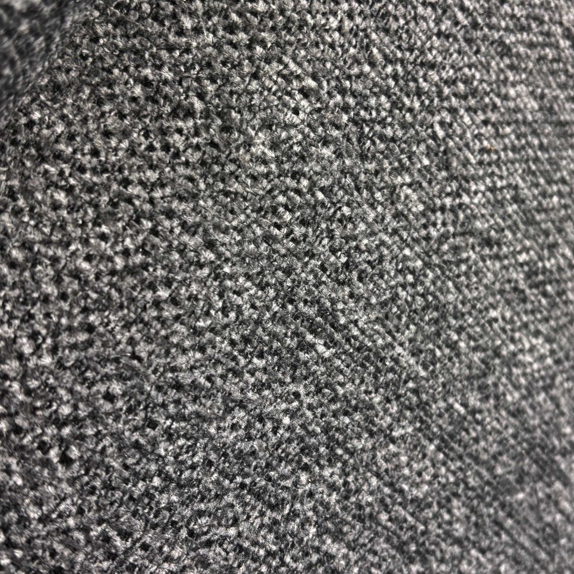Close up view of the durable charcoal grey weave fabric and quality stitching on the Costa sofa.