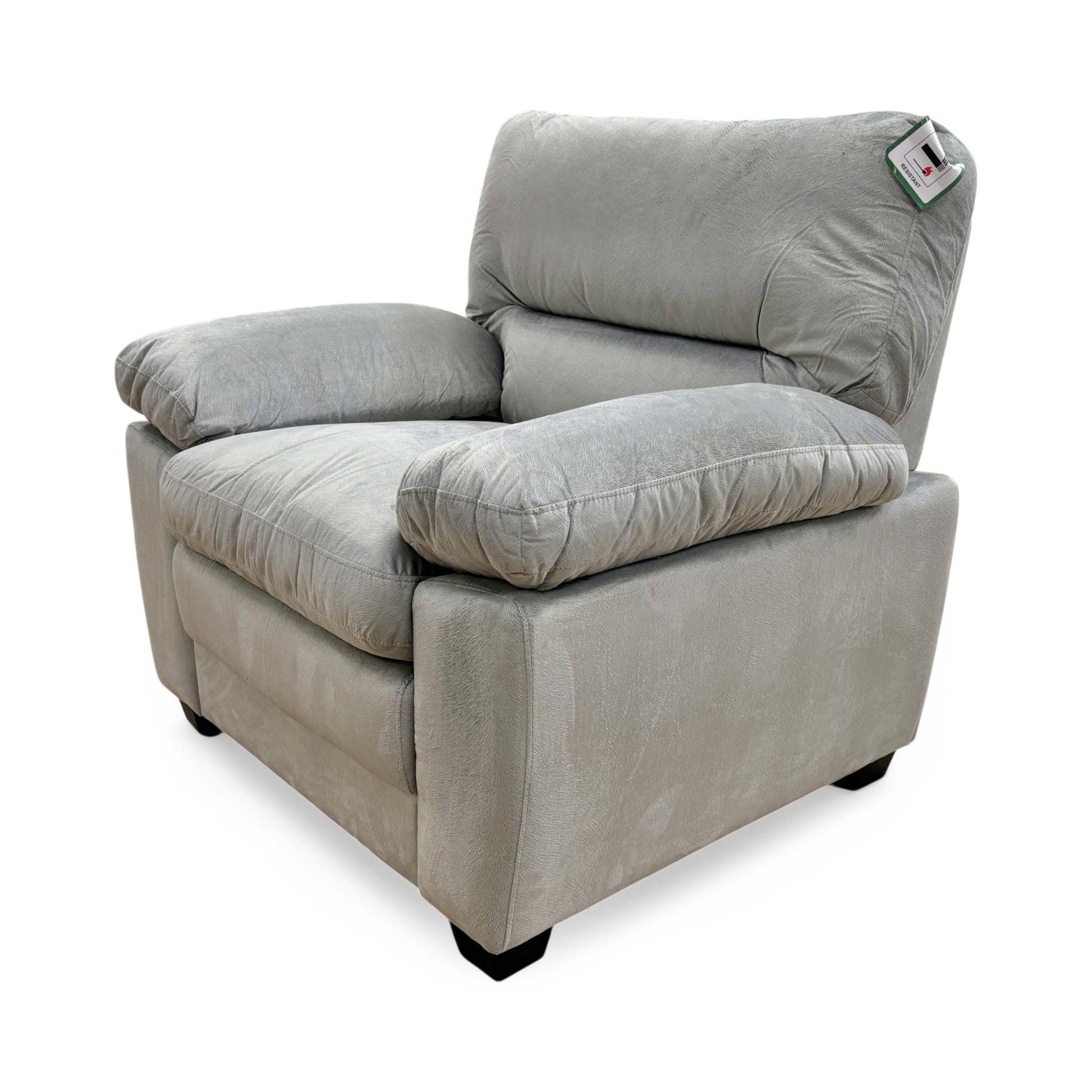 Side view of the Jordan armchair showing the sleek profile and tapered wooden legs.