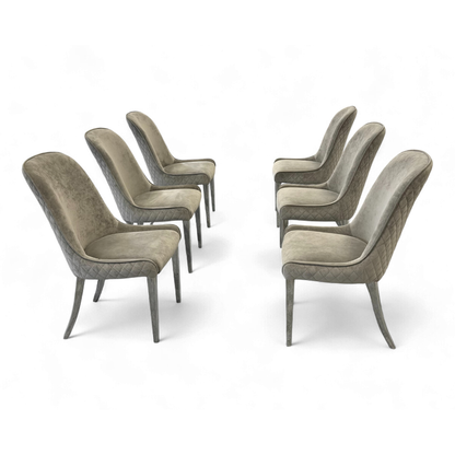 Side view of Three 'Gabana' stone velvet dining chairs pulled up to a dining table (or positioned together) to show scale and context.