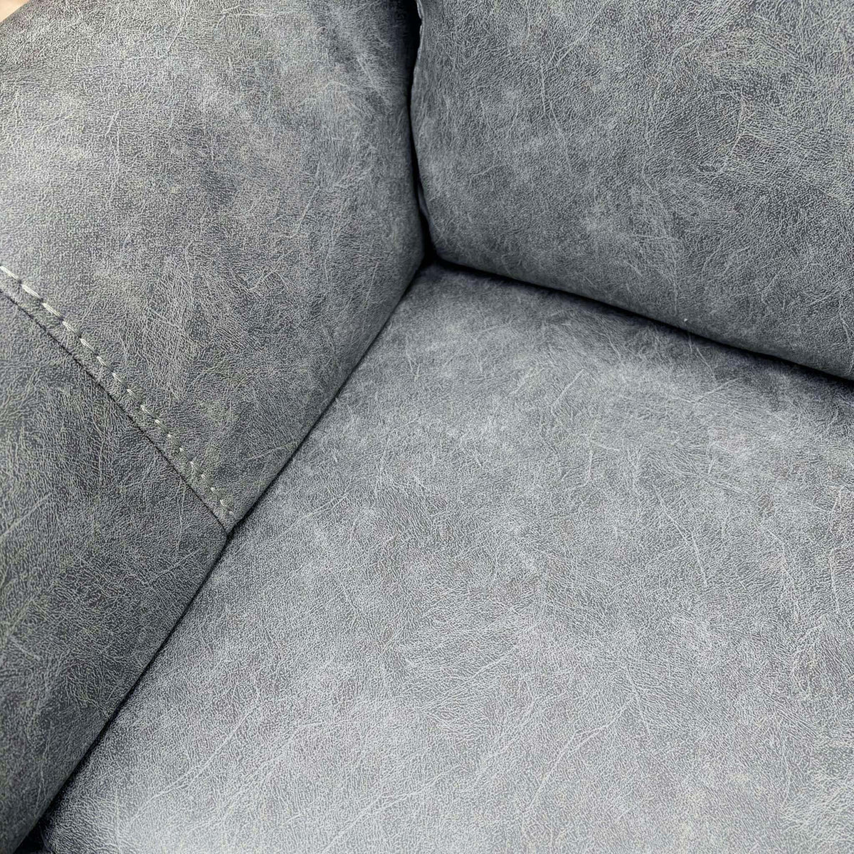 Close-up of the grey endurance fabric on the seat and arm of the Azzurri recliner sofa
