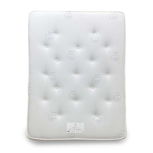 Wide-angle shot of the Lottie Wool Tuft & Snooze King Mattress, showing the plush tufted white surface.